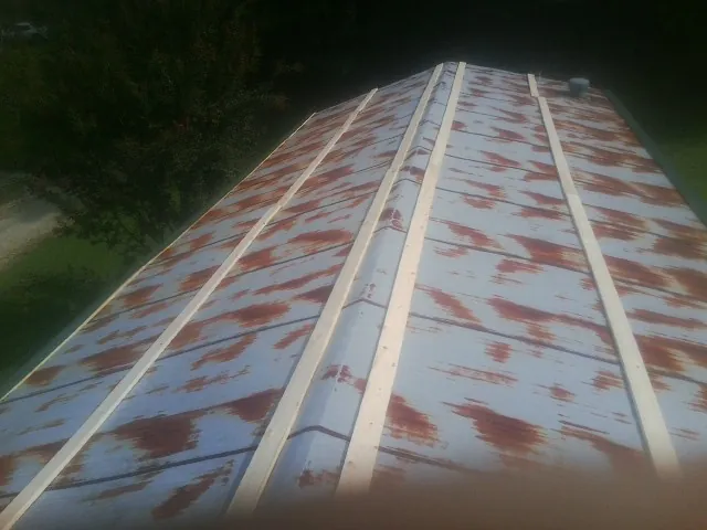 Rusted metal roof panels with new wood purlins before replacement — Storm Damage Roof Repair in Sea Girt by Roofing Brothers